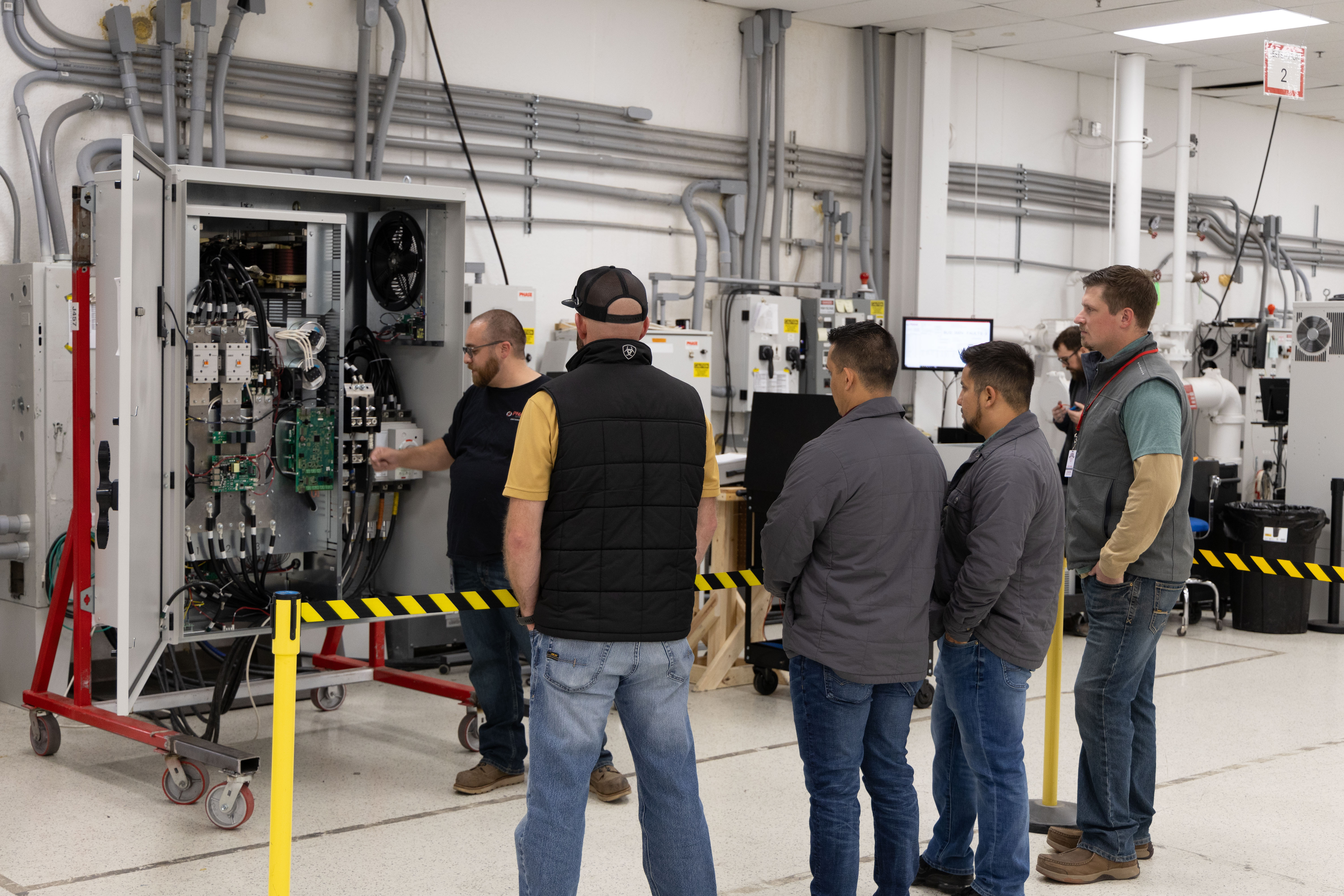 Phase Technologies team reviewing a panel build on the floor