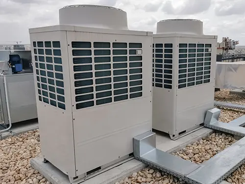 Two three-phase VRF condenser units installed on a commercial rooftop
